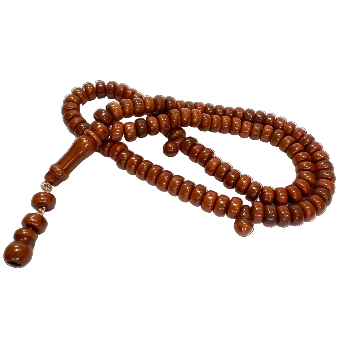 Brown plastic 99-bead tasbih laid out on white, the tapered imam bead and two counter beads at the lower left