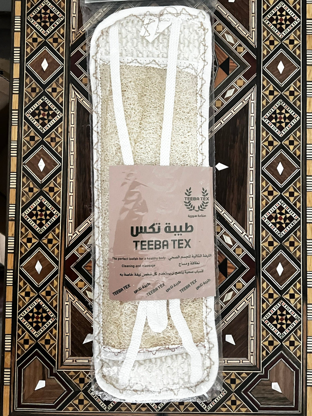 Teeba Tex loofah back scrubber strap with white strap handles in its clear retail bag